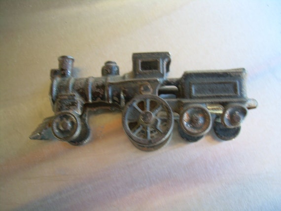 Vintage cast iron toy steam locomotive with attached coal