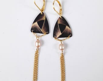Triangular earrings etched brass with a decorative pattern reminiscent of a Ribbon.