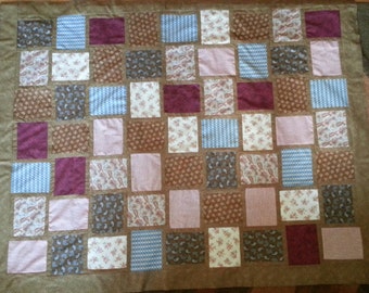 Quilt TOP in woven browns, steal blues, reds and creams. This quilt top is pieced together and read for quilting