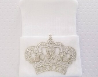 Newborn hospital hat with oversized silver crown.
