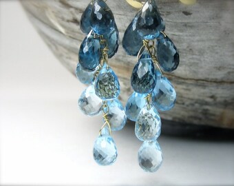 Blue topaz earrings in 18K gold. Swiss London blue topaz dangle earrings. Blue gemstone cascade briolette earrings. November birthstone.