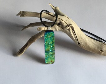 A beautiful gold and green dichroic fused glass pendant with a silver plated bail.