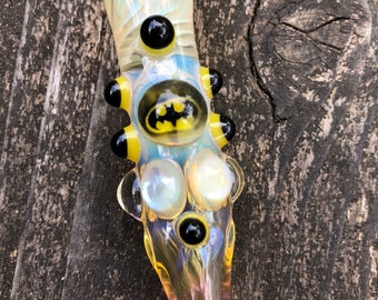 BATMAN Glass pipe is a fumed one hitter. Hand blown BATMAN Millie with highlights. Color changing. Flat mouth piece.