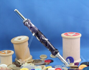 Double Blade Seam Ripper (Chrome Finished). Has 1 small blade and 1 large blade. Deep Purple and White Alumilite Resin Handle. Item 25
