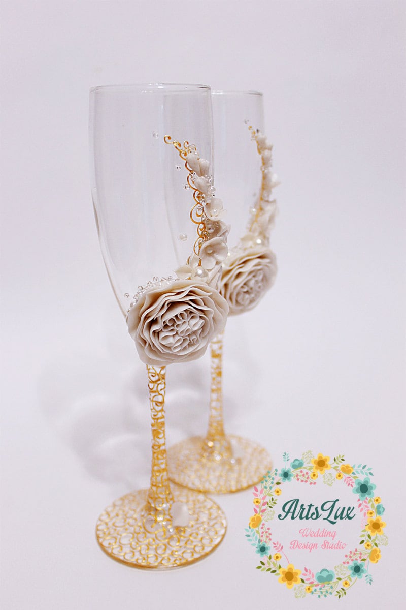 Wedding champagne glasses with beautiful flower in