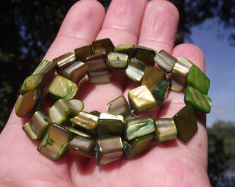 6 GREEN 10-14 MM SHELL BEADS.