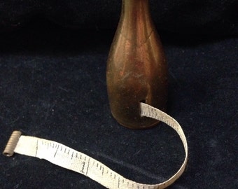 Antique Champagne bottle measuring tape