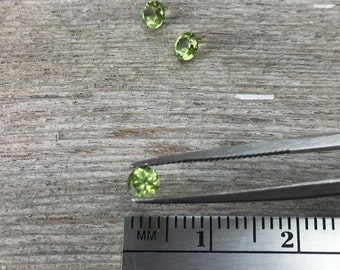 One 3.5mm faceted peridot semiprecious gemstone, light yellow green