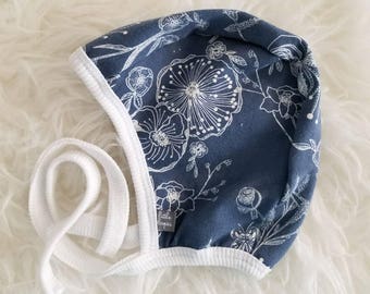 Blue with white flower outline pilot hat by Little Lapsi. Baby hat with ties.