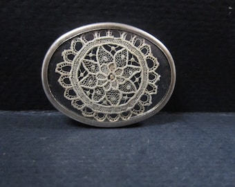Silver brooch with very fine embroidery