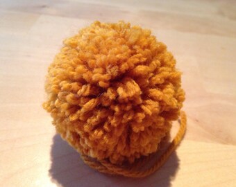Made to order, extra fluffy mustard pom pom from sizes small, medium, large and extra large.