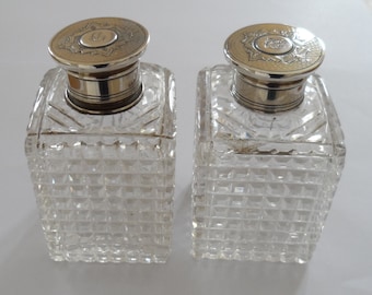 A pair of antique silver screw topped, hobnail cut, glass perfume bottles circa 1910 - 1920s.