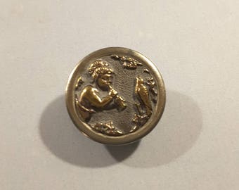 19th Century button of cherub playing a flute.