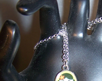 Necklace little Japanese gheisha on green background