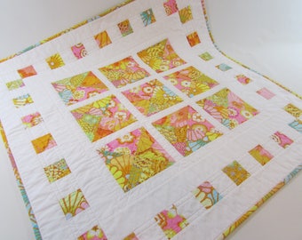 Quilted Square Table Topper in bright pastel Kaffe Fassett prints adds colorful beauty to your home!