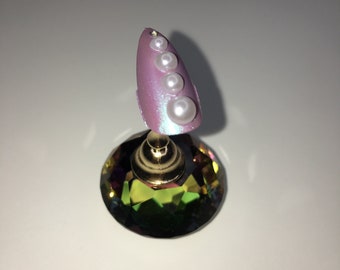 Pot of flat back pearls for nail art.