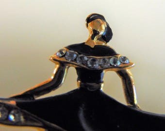 1950s lady with wind blown skirt brooch