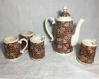 Ceramic teapot with matching cups