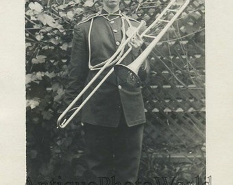 Woman in military uniform w trombone antique photo