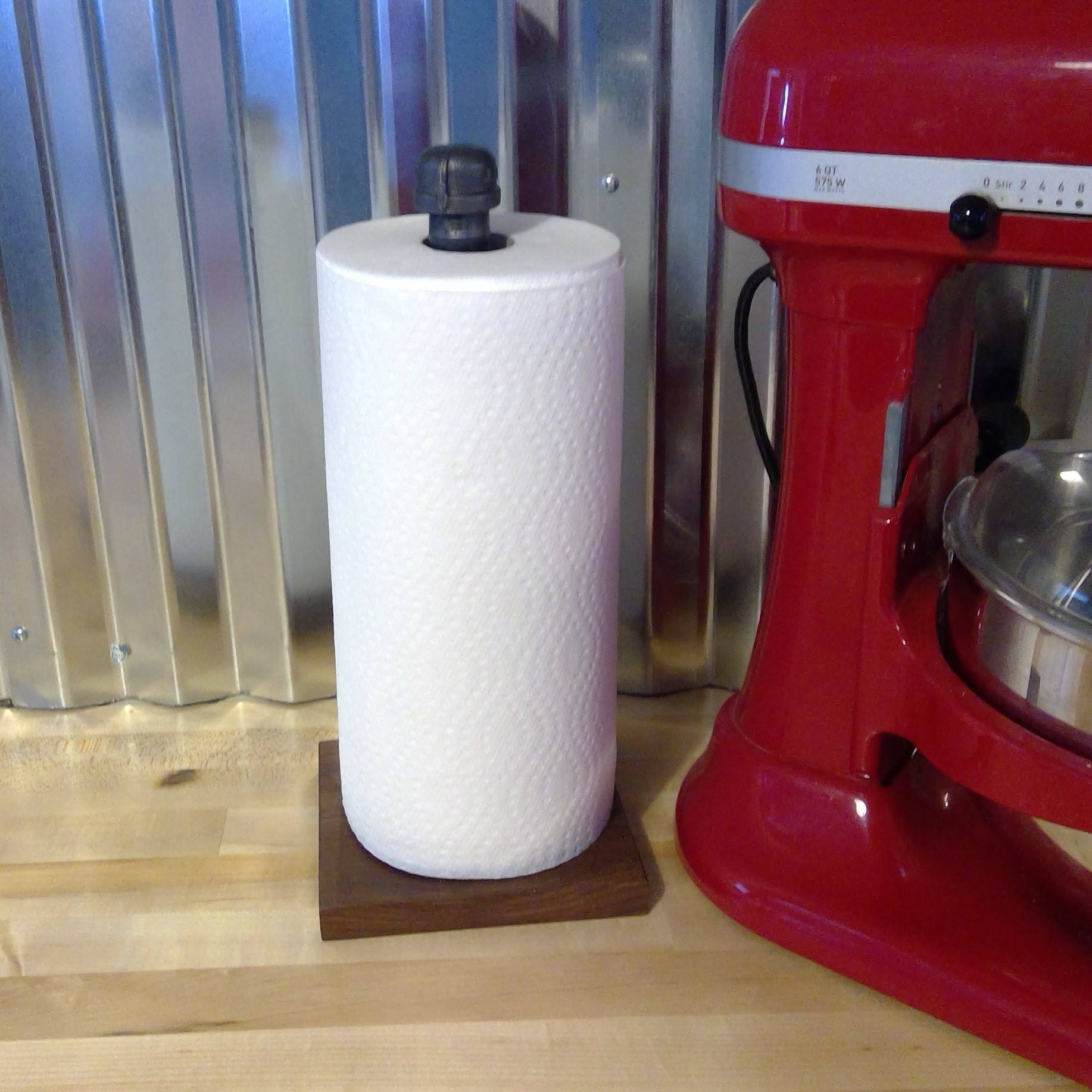 Pipe paper towel holder on a Walnut base.