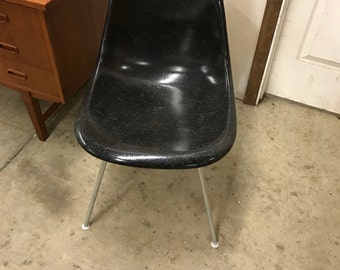 Black herman Miller fiberglass shell chair.