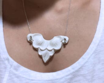 A delicate porcelain pendant with chain