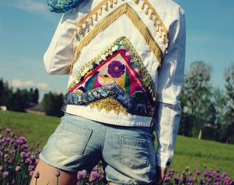 Denim jacket with tassels, fringes, and coins