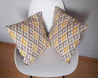 Pillow cover with geometric patterns in yellow mustard, beige and light brown