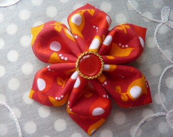Kanzashi flower brooch in orange with small red and gold button with red fabric