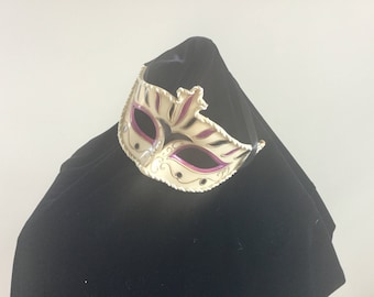 Cream and purple masquerade mask.