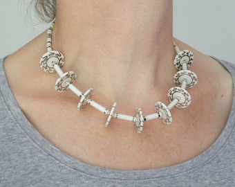 Porcelain discs necklace, transparent glazed porcelain with wiggle design in platinum, fine tubes with platinum lustre, silver clasp