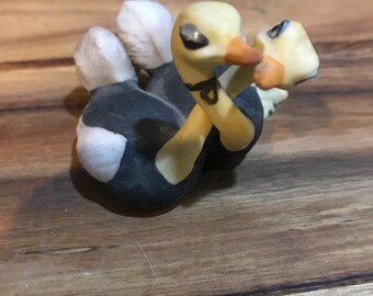 Adorable necking ostriches miniature figurine.