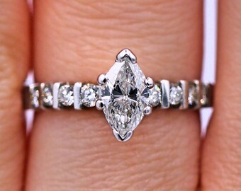Delicate engagement ring with 0.55cts marquise shape diamond