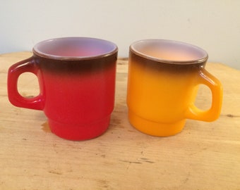 Set of two vintage red and yellow Fire King milk glass coffee mug tea cups great mid century design!