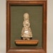 Stone figurine of young girl.