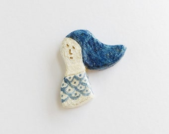 That defies and clay brooch