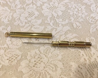 Brass, stiletto, with ring on top, a sewing tool, 4 3/4" long