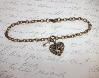 Filigree heart charm bracelet with crystal in antique brass / bronze