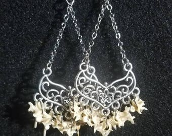 Real snake vertebrae chandelier earrings.