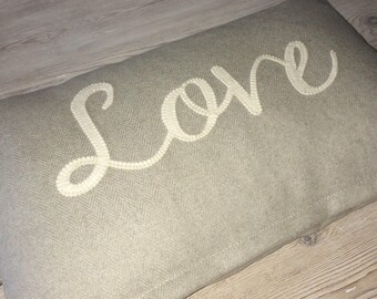 Beautiful cushion with 'Love' appliqué