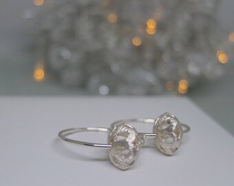 Sterling silver hoop earrings with sterling silver brushed finish filigree bead.