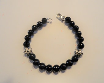 Bracelet Made With Black Glass Beads Flower Spacers in Middle
