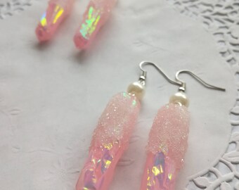 Holographic pink crystals in resin earrings.