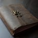 Elegant journal in brown goat leather, midori structure, replaceable internal sections and bronce latch.