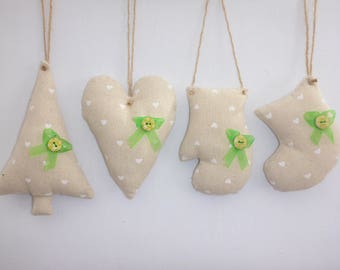 Rustic fabric Christmas tree ornaments in cream/white heart fabric. Pretty painted buttons, green ribbon and rustic twine for hanging.