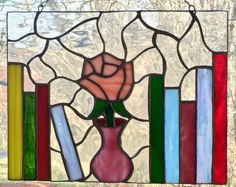 Bookshelf with rose