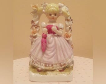 Vintage Girl Beneath Floral Trellis Figurine