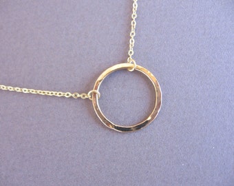 Hammered gold hoop necklace.