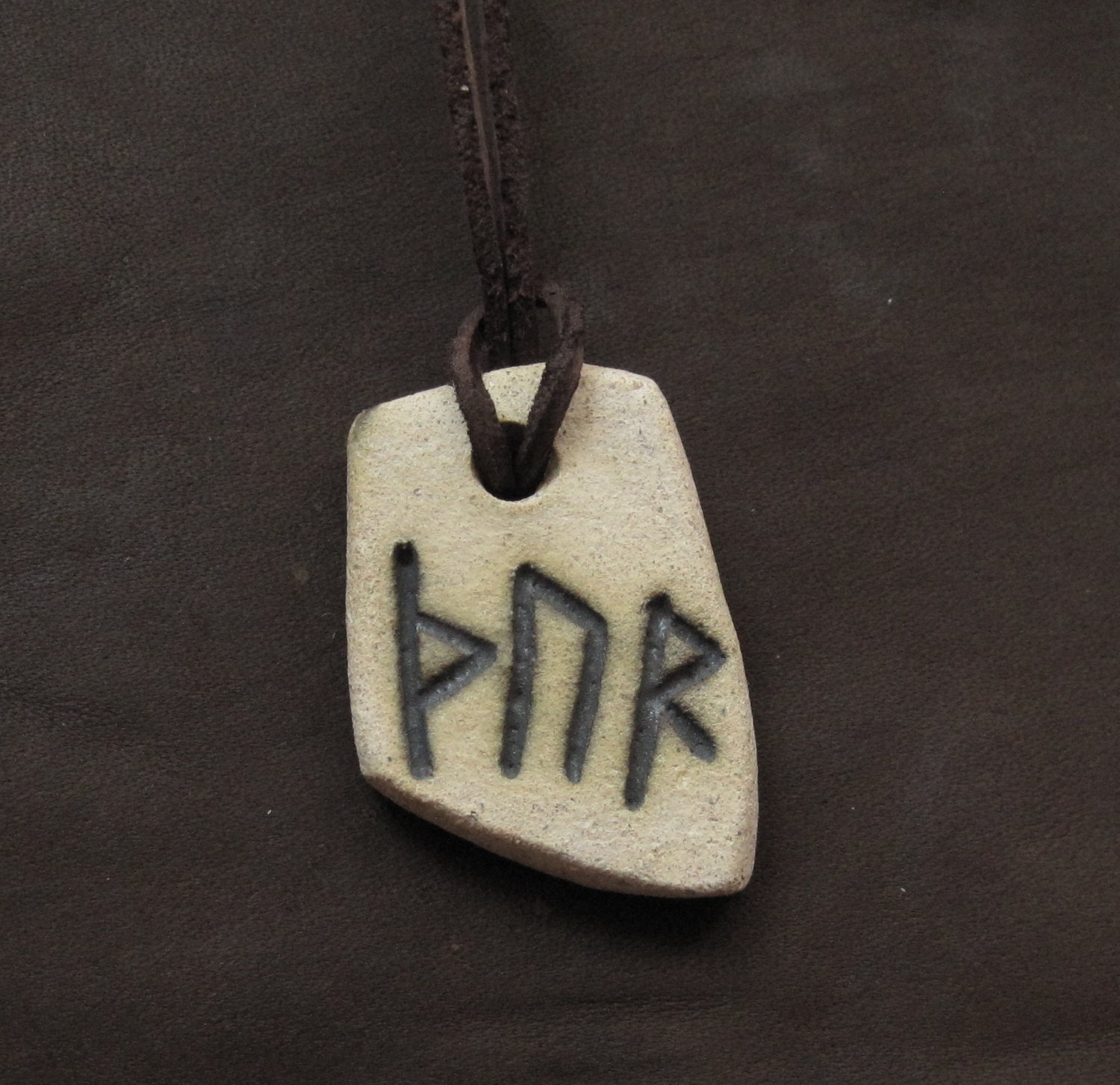 pendant with the name of Thor written in rune. Viking runes