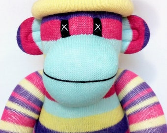 Fun Striped Sock Monkey with a removable yellow pom pom hat